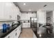 Kitchen featuring granite countertops, stainless steel appliances, and white cabinetry at 884 Golden Bear Dr, Reunion, FL 34747