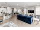Open-concept living and kitchen area, featuring tile floors, a large TV, and bar seating at 884 Golden Bear Dr, Reunion, FL 34747
