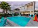 Enjoy a private pool, attached spa, and patio with outdoor seating in this stunning backyard retreat at 884 Golden Bear Dr, Reunion, FL 34747