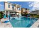 Backyard pool features playful amenities, attached spa and outdoor furniture with a patio at 884 Golden Bear Dr, Reunion, FL 34747