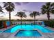 Backyard pool with palm trees, lake view and a fun Connect Four game at 884 Golden Bear Dr, Reunion, FL 34747