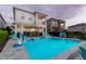 Private pool with spa, poolside seating and playful amenities surrounded by lush landscaping in backyard at 884 Golden Bear Dr, Reunion, FL 34747