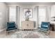 Sitting area with two armchairs, decorative art, and plenty of natural light at 884 Golden Bear Dr, Reunion, FL 34747