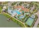 An aerial view of a resort-style pool with lazy river, splash pad, basketball court and lake pier at 8900 Sydney Ave, Kissimmee, FL 34747