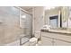 Bathroom featuring shower, toilet, granite countertop and white cabinets at 8900 Sydney Ave, Kissimmee, FL 34747