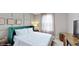 Cozy bedroom with a plush green headboard, soft white linens and modern decor at 8900 Sydney Ave, Kissimmee, FL 34747
