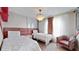 Bright bedroom with twin beds, decorative chandelier, and stylish decor at 8900 Sydney Ave, Kissimmee, FL 34747