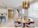 Charming dining area next to kitchen featuring modern lighting fixture and stairwell at 8900 Sydney Ave, Kissimmee, FL 34747