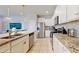 Modern kitchen with granite countertops and stainless steel appliances adjacent living area at 8900 Sydney Ave, Kissimmee, FL 34747