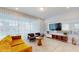 Bright living room featuring stylish furniture, a unique wall mirror, and large windows at 8900 Sydney Ave, Kissimmee, FL 34747