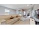 Open living room with sectional sofa and views into neighboring rooms at 8900 Sydney Ave, Kissimmee, FL 34747