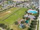 Aerial view of community featuring a soccer field, playground, community pool and well-maintained green spaces at 914 Fallon Hills Dr, Haines City, FL 33844