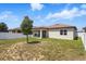 Spacious backyard featuring a covered patio, complemented by a privacy fence and lush landscaping at 914 Fallon Hills Dr, Haines City, FL 33844