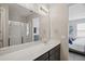Bathroom featuring a large mirror, a vanity with storage, and a glass-enclosed shower at 914 Fallon Hills Dr, Haines City, FL 33844