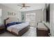 Bright bedroom with a ceiling fan, a large window, and a comfortable bed at 914 Fallon Hills Dr, Haines City, FL 33844