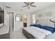 Bright bedroom with a ceiling fan, a large window, and a comfortable bed and ensuite bath at 914 Fallon Hills Dr, Haines City, FL 33844
