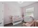 This Bedroom features pale pink walls and a white crib at 914 Fallon Hills Dr, Haines City, FL 33844
