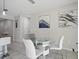 Dining area features a modern glass table and white chairs, creating a cozy space at 914 Fallon Hills Dr, Haines City, FL 33844