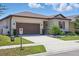 Charming single-story home with well-maintained landscaping and a two-car garage at 914 Fallon Hills Dr, Haines City, FL 33844