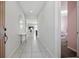 Bright hallway with tile flooring, leading to various rooms in the house at 914 Fallon Hills Dr, Haines City, FL 33844
