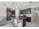 Open-concept kitchen featuring dark wood cabinets and a spacious granite island at 914 Fallon Hills Dr, Haines City, FL 33844