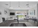 Open-concept living space featuring a kitchen island, dining area, and sliding glass doors to the backyard at 914 Fallon Hills Dr, Haines City, FL 33844