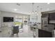 Open-concept living space featuring a kitchen island, dining area, and sliding glass doors to the backyard at 914 Fallon Hills Dr, Haines City, FL 33844