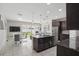Open-concept living space featuring a kitchen island, dining area, and sliding glass doors to the backyard at 914 Fallon Hills Dr, Haines City, FL 33844