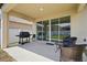 Covered patio with a grill and outdoor seating area at 914 Fallon Hills Dr, Haines City, FL 33844