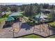 Community playground featuring a variety of play structures, picnic benches, and safety surfacing at 914 Fallon Hills Dr, Haines City, FL 33844