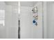 Close-up of the glass-enclosed shower with white tile and modern fixtures at 914 Fallon Hills Dr, Haines City, FL 33844