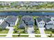 Aerial view of home, neighboring houses, and pond in planned community at 9352 Santorini Dr, Orlando, FL 32827