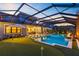 Backyard with pool and putting green at dusk at 9352 Santorini Dr, Orlando, FL 32827