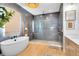 Spa-like bathroom with soaking tub, walk-in shower, modern fixtures, and wood-look tile flooring at 9352 Santorini Dr, Orlando, FL 32827