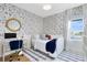 Well lit bedroom with a twin bed, patterned wallpaper, and large windows for natural light at 9352 Santorini Dr, Orlando, FL 32827