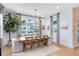 Bright dining room featuring a wooden table, chandelier, and views of the outside at 9352 Santorini Dr, Orlando, FL 32827