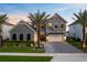 Beautiful gray two-story home featuring a manicured front yard and paver driveway at 9352 Santorini Dr, Orlando, FL 32827