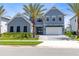 Beautiful exterior front of two-story home with palm trees, large windows and a driveway at 9352 Santorini Dr, Orlando, FL 32827