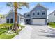 Stunning exterior view with a circular driveway, palm tree and well-maintained landscaping at 9352 Santorini Dr, Orlando, FL 32827
