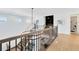 Bright foyer with wood floors, stylish chandelier, and sleek railings create a modern and welcoming entrance to this home at 9352 Santorini Dr, Orlando, FL 32827