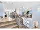 Bright and airy foyer features elegant railings, light wood floors, and a chandelier, showcasing the home's inviting atmosphere at 9352 Santorini Dr, Orlando, FL 32827