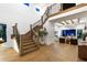Grand foyer with high ceilings, wooden staircase, and views into the living area at 9352 Santorini Dr, Orlando, FL 32827