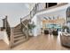 Grand foyer with high ceilings, wooden staircase, and views into the living area at 9352 Santorini Dr, Orlando, FL 32827