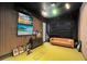 Indoor golf simulator room features a large leather couch and TV's for entertainment at 9352 Santorini Dr, Orlando, FL 32827