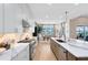 Bright kitchen with white cabinets, stone countertops, stainless steel appliances, and center island at 9352 Santorini Dr, Orlando, FL 32827