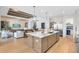 Gourmet kitchen with a large island, stainless steel appliances, and an open layout to the living room at 9352 Santorini Dr, Orlando, FL 32827