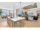 Open-concept kitchen with a center island, stainless steel appliances, and views of the living area at 9352 Santorini Dr, Orlando, FL 32827