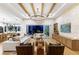 Open living room with beamed ceilings, comfortable seating, and views to the outdoor pool area at 9352 Santorini Dr, Orlando, FL 32827