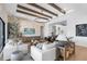 Inviting living room featuring wood beams, stone accent wall, and stylish decor at 9352 Santorini Dr, Orlando, FL 32827