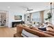 Comfortable living room boasts a large sofa, modern entertainment center, and abundant natural light, perfect for relaxation and entertainment at 9352 Santorini Dr, Orlando, FL 32827